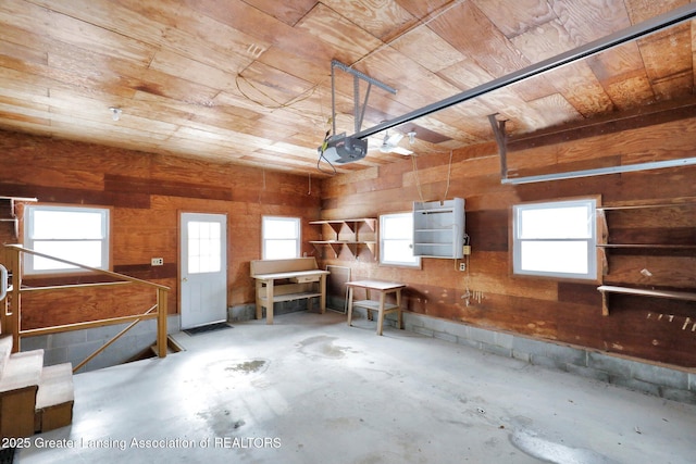 garage with a garage door opener and wooden ceiling