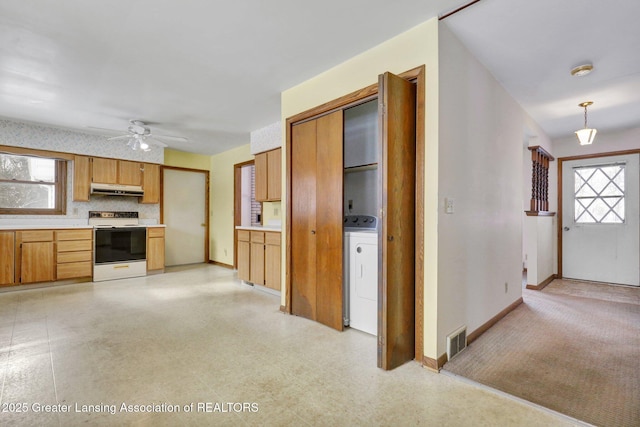 kitchen featuring washer / dryer, electric range, ceiling fan, and decorative backsplash