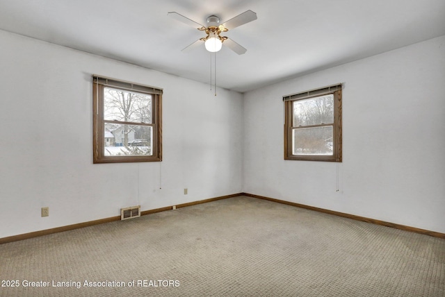 carpeted empty room with ceiling fan