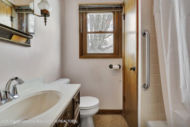 bathroom featuring vanity, curtained shower, a wealth of natural light, and toilet