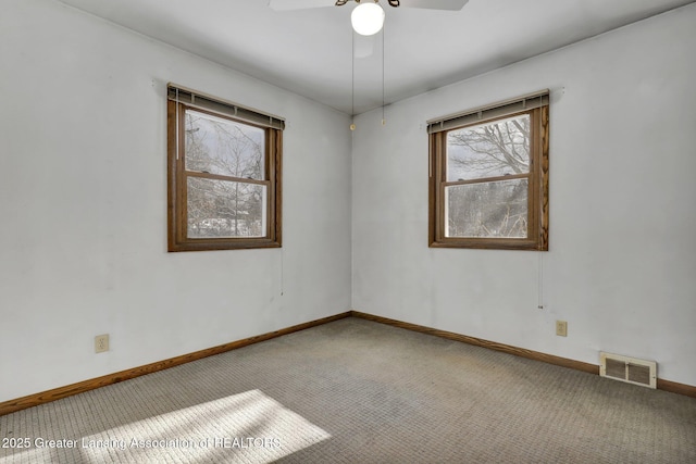 carpeted empty room featuring ceiling fan