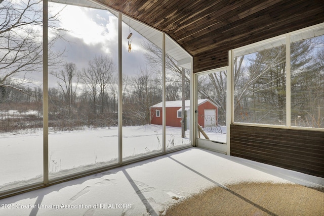 unfurnished sunroom featuring lofted ceiling and a wealth of natural light