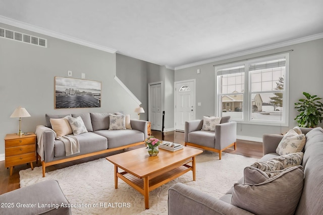 living room with crown molding and hardwood / wood-style flooring