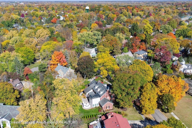 aerial view with a wooded view and a residential view