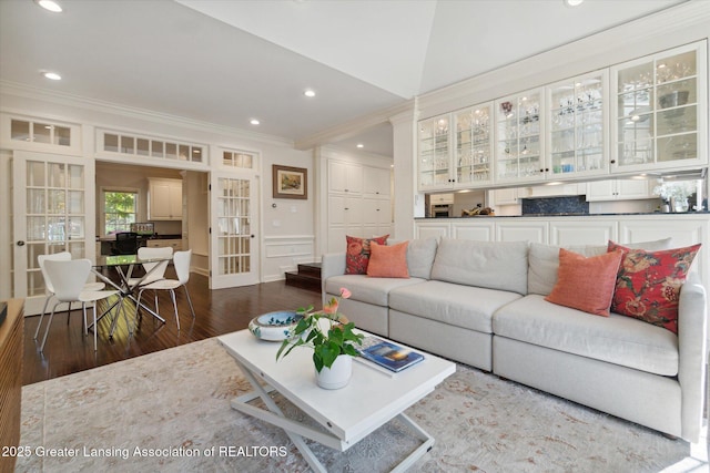 living area featuring french doors, ornamental molding, dark wood-type flooring, and recessed lighting