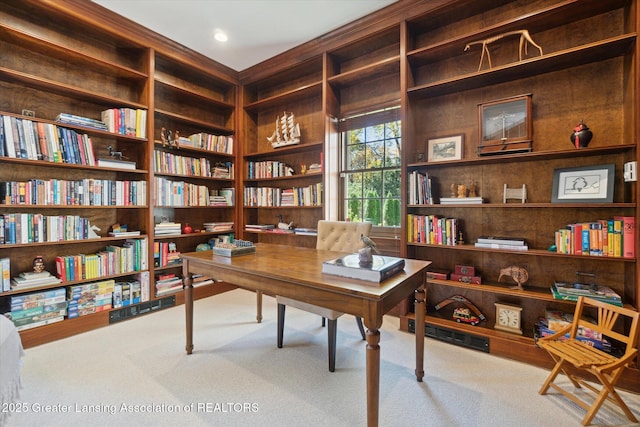 carpeted office featuring built in shelves