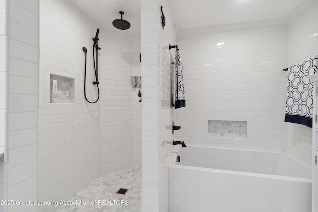 bathroom with a tub and a tile shower