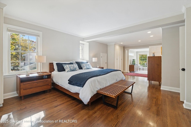 bedroom with dark wood-style floors, recessed lighting, crown molding, and baseboards