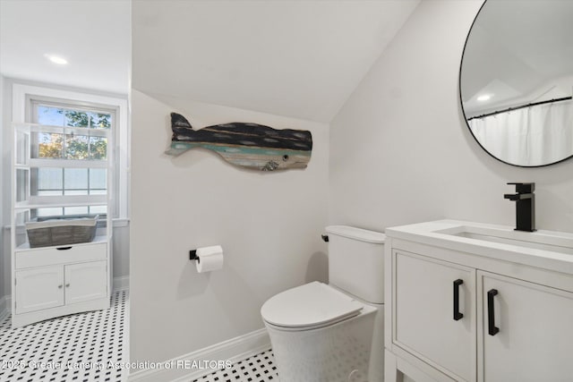 full bath with baseboards, vaulted ceiling, vanity, and toilet