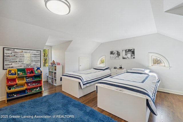 bedroom featuring vaulted ceiling, wood finished floors, and baseboards