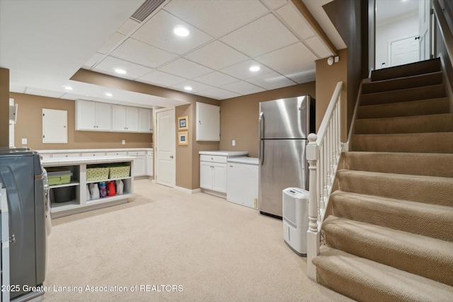 kitchen featuring light carpet, recessed lighting, freestanding refrigerator, and white cabinetry