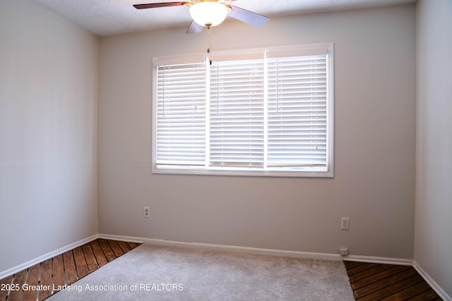 empty room with ceiling fan and a textured ceiling