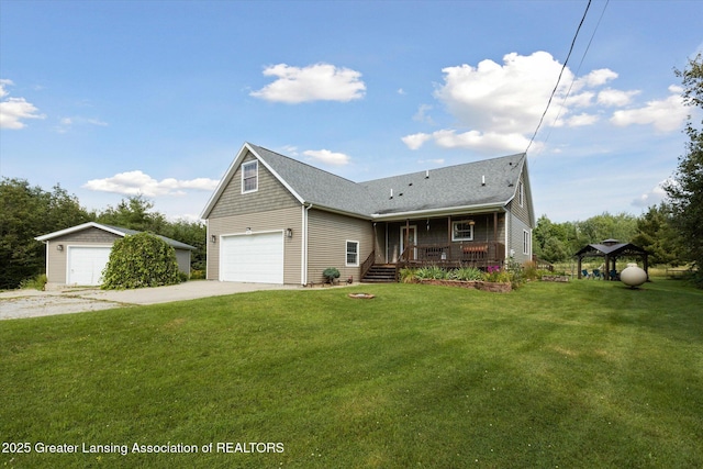 view of front of property featuring a garage, a front yard, and covered porch