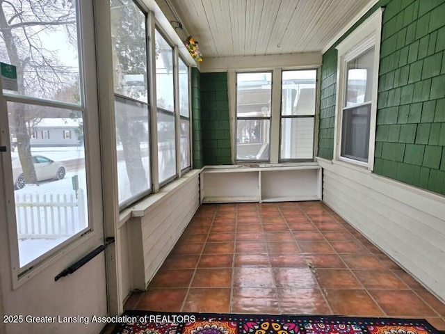 unfurnished sunroom featuring wood ceiling