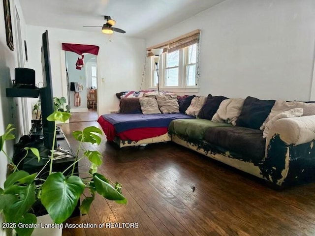 living room featuring dark hardwood / wood-style flooring and ceiling fan