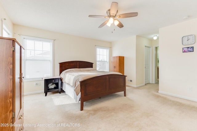 bedroom with ceiling fan, baseboards, and light colored carpet