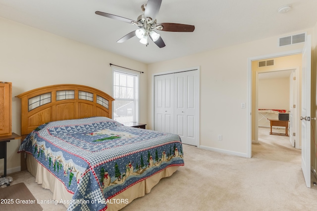 bedroom with light colored carpet, a closet, visible vents, and baseboards