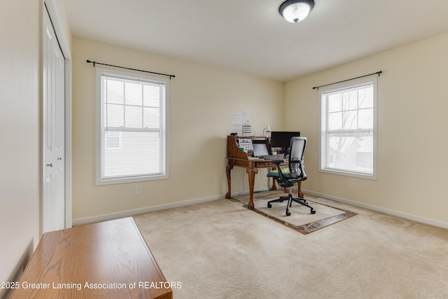 carpeted office featuring a healthy amount of sunlight and baseboards