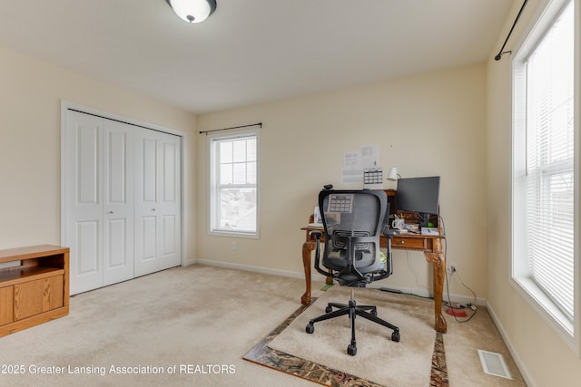 carpeted home office with baseboards and visible vents