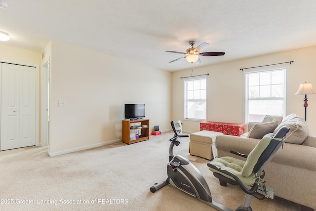 carpeted living area with ceiling fan, visible vents, and baseboards