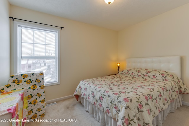 carpeted bedroom featuring visible vents and baseboards