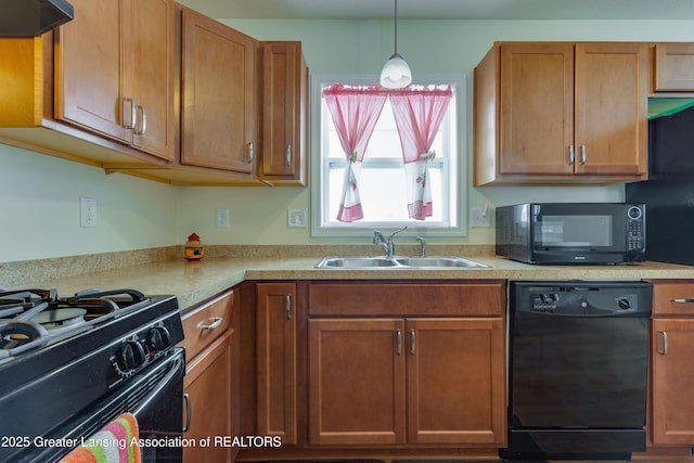 kitchen featuring black appliances, a sink, light countertops, and under cabinet range hood