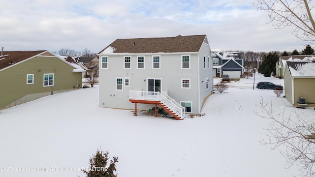 snow covered house featuring stairway and a residential view