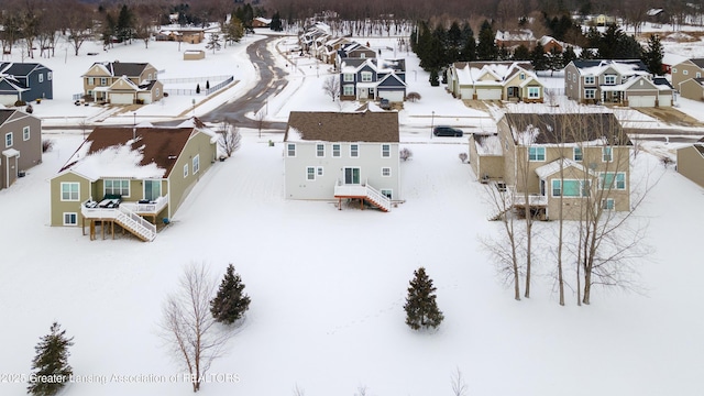 snowy aerial view with a residential view