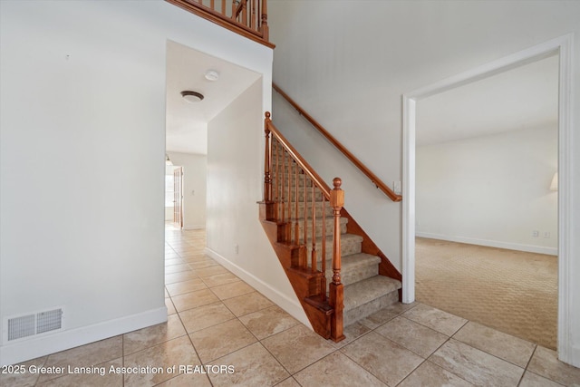 stairs featuring carpet flooring