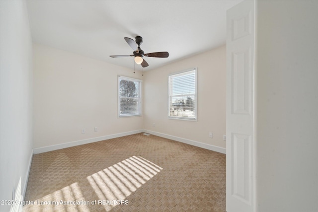 unfurnished room with light colored carpet and ceiling fan