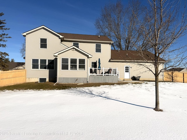 view of snow covered back of property