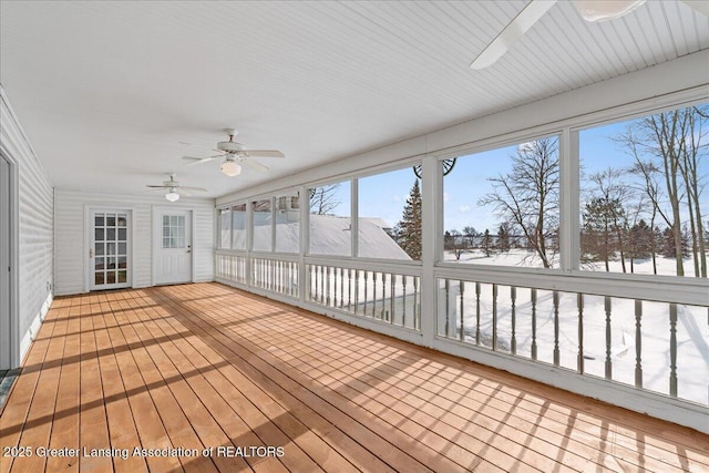 unfurnished sunroom with ceiling fan