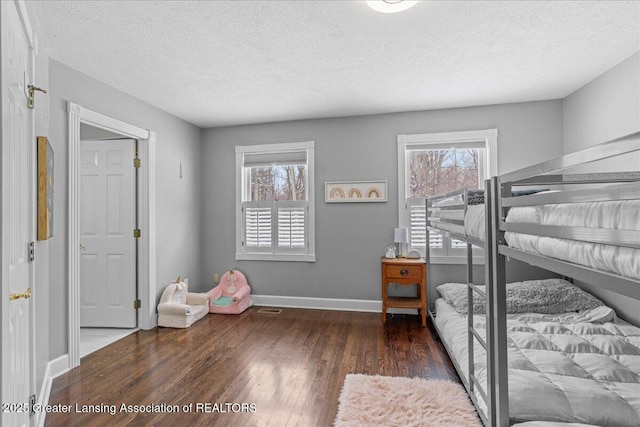 bedroom featuring dark hardwood / wood-style floors and a textured ceiling