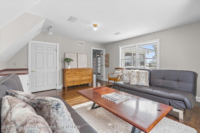 living room with hardwood / wood-style flooring and a textured ceiling