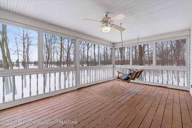 unfurnished sunroom with ceiling fan