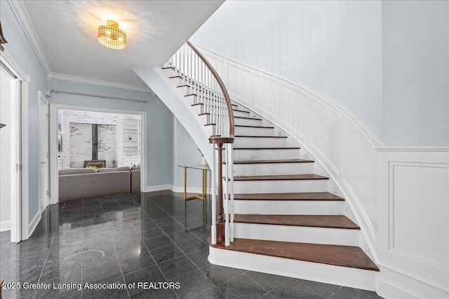 stairs with ornamental molding and a wood stove