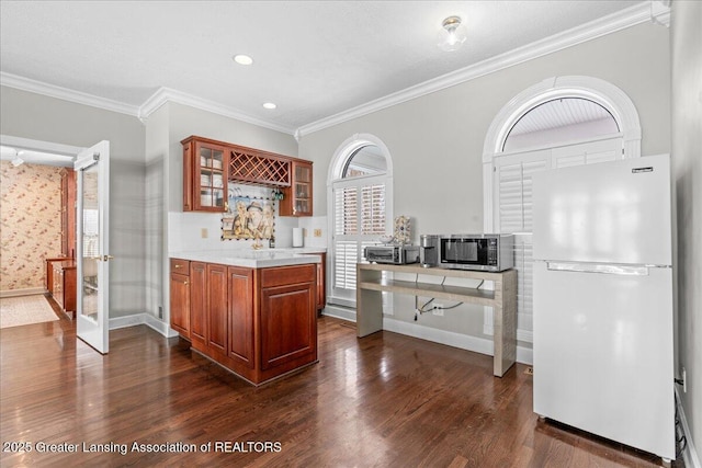 kitchen featuring dark hardwood / wood-style flooring, crown molding, and white fridge