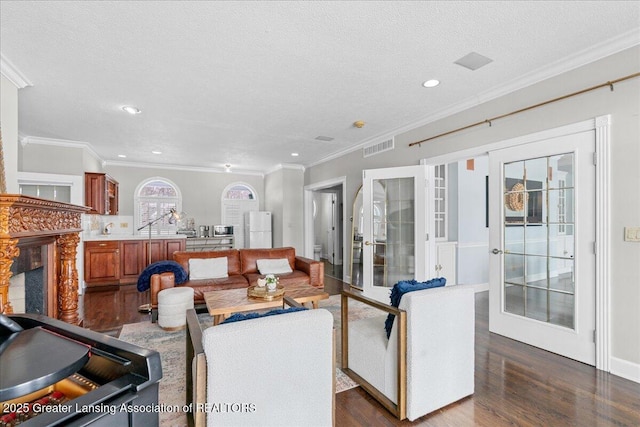 living room featuring ornamental molding, dark hardwood / wood-style flooring, a textured ceiling, and french doors