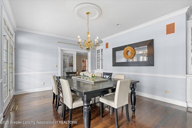 dining area featuring crown molding, dark hardwood / wood-style flooring, an inviting chandelier, and french doors