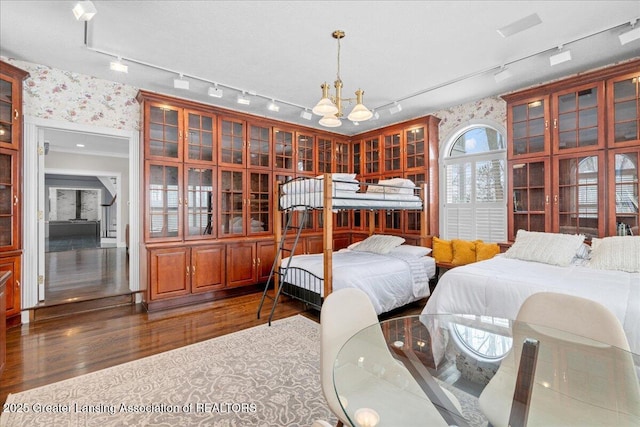 bedroom featuring dark hardwood / wood-style floors and a chandelier