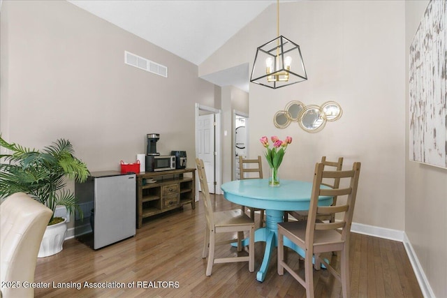 dining space with hardwood / wood-style flooring and lofted ceiling