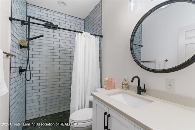 bathroom with vanity, walk in shower, and toilet