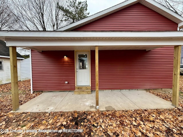 property entrance with a carport