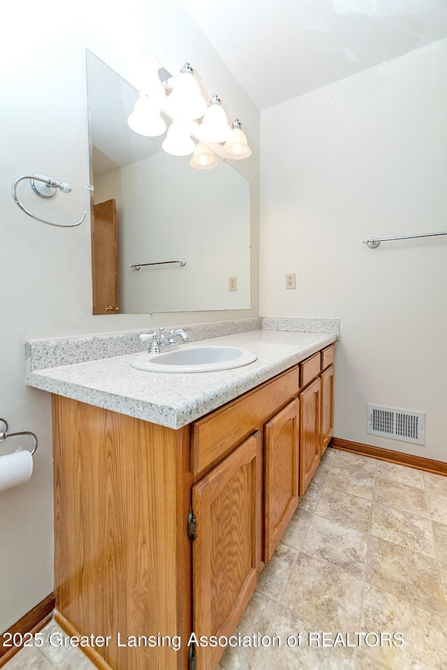 bathroom featuring an inviting chandelier and vanity