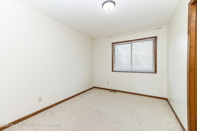 unfurnished room with light colored carpet