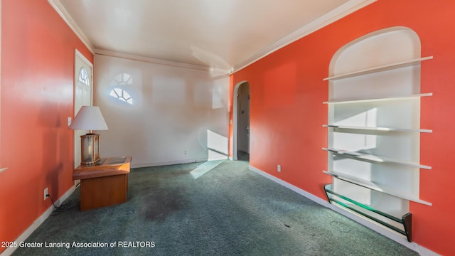 unfurnished room with crown molding and dark colored carpet