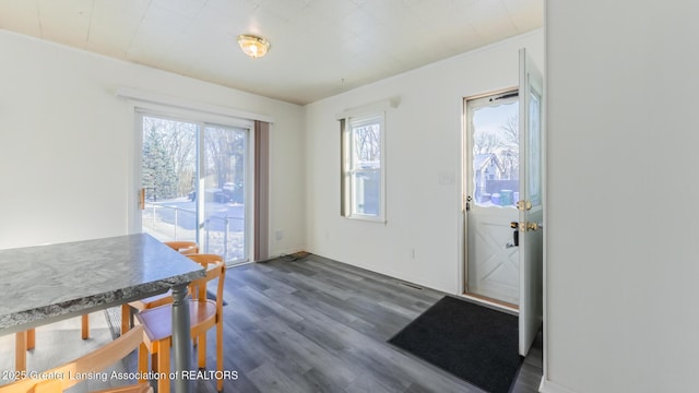 dining space with dark wood-type flooring