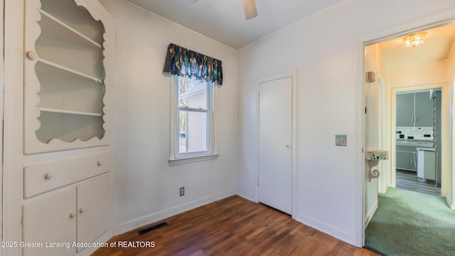 unfurnished bedroom with dark hardwood / wood-style flooring and ceiling fan