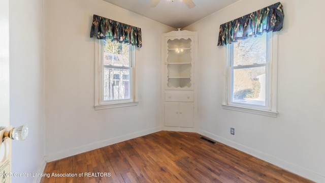 unfurnished room featuring dark hardwood / wood-style floors and ceiling fan