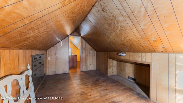 bonus room with lofted ceiling, wood ceiling, wood-type flooring, and wooden walls